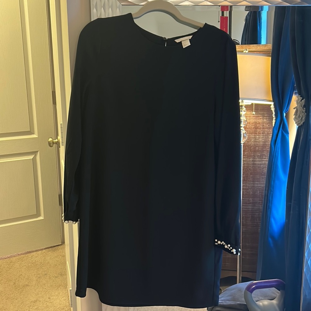Black dress with pearl accent.